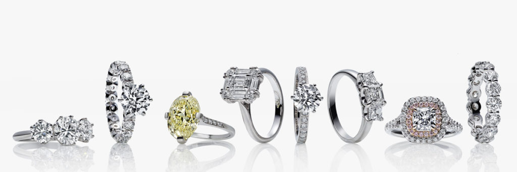 A group of four rings with different designs on them.