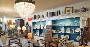 A room filled with lots of furniture and plates. A room filled with lots of furniture and plates.