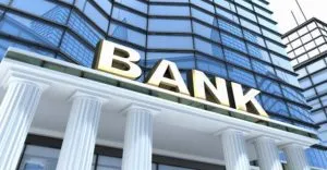 A bank sign is shown on the side of a building. A bank sign is shown on the side of a building.