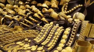 A table filled with lots of gold jewelry. A table filled with lots of gold jewelry.