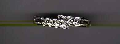 A pair of silver earrings with diamonds on top.